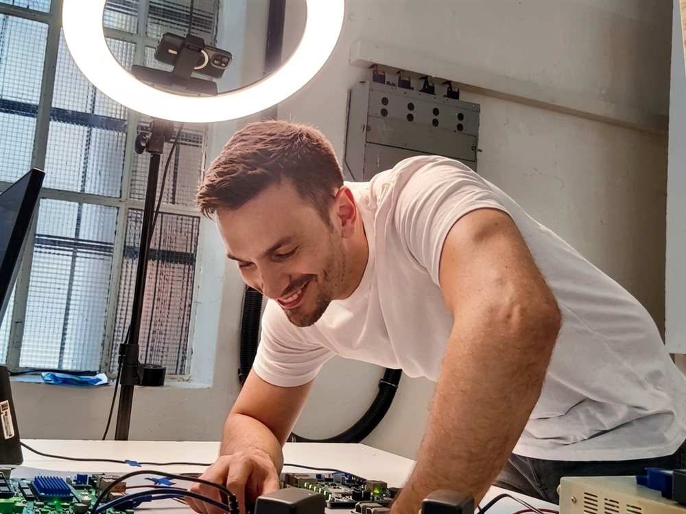 Alessandro Berruti working on a circuit board at his bench